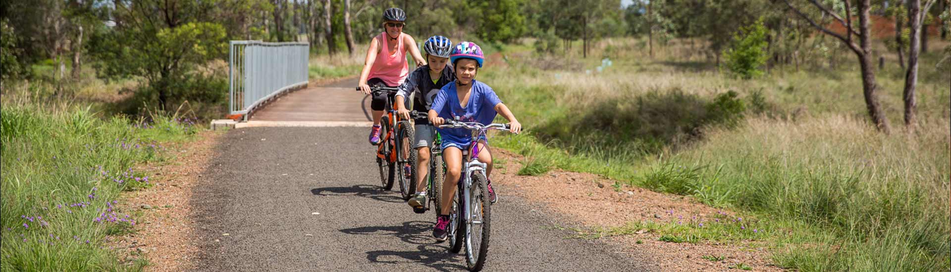 Family riding bike on path